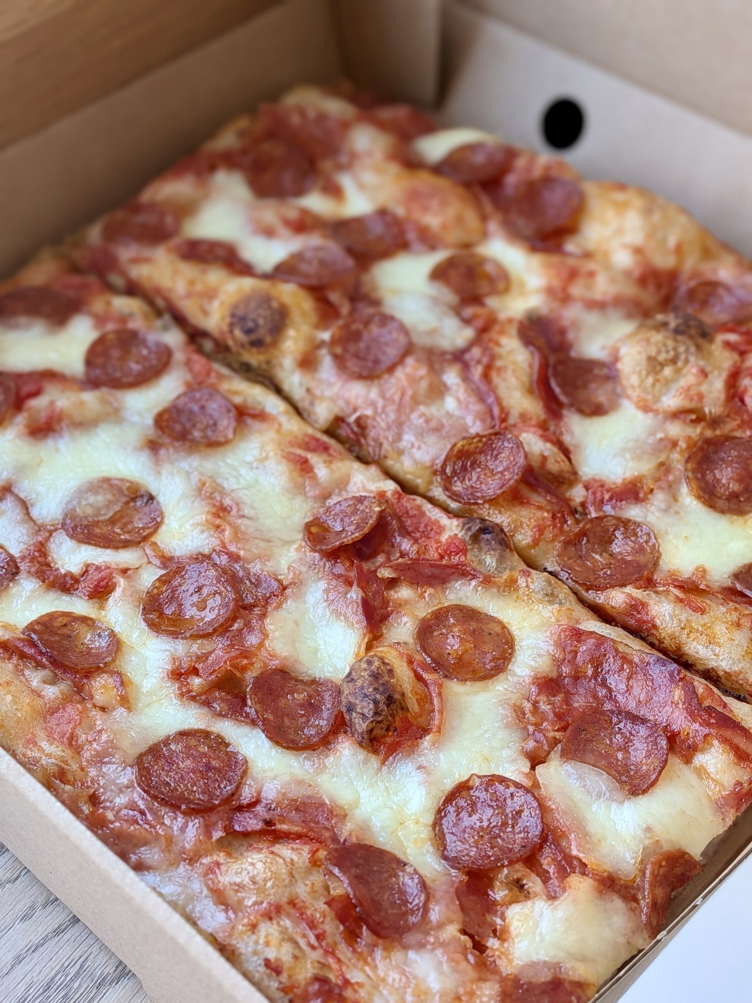 Pepperoni piccante Roman-style pizza slices in a box